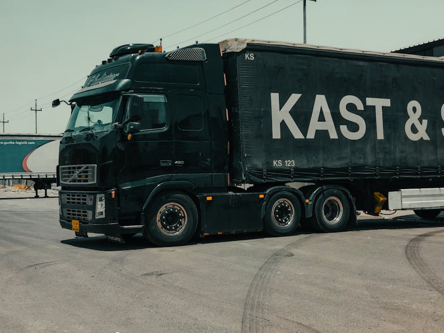 A large industrial truck parked in an urban setting, showcasing transportation industry visuals.